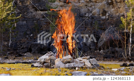 Beautiful Crackling Campfire in a Rocky Landscape , Sunrise , Authentic Place 124368113