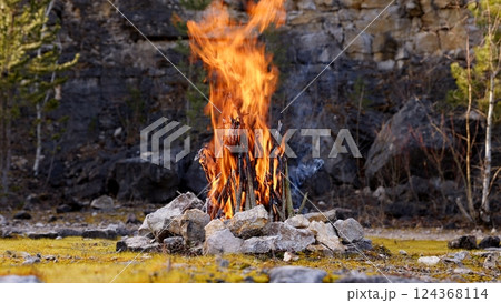 Beautiful Crackling Campfire in a Rocky Landscape , Sunrise , Authentic Place 124368114