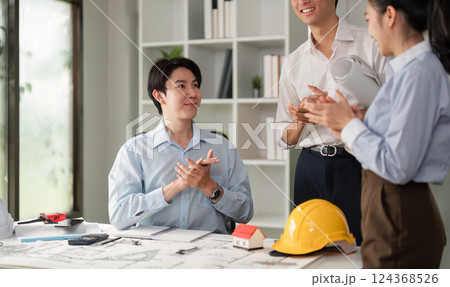 Success and Collaboration. Team members clapping in success, celebrating their project achievements while fostering a positive work environment. 124368526