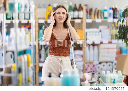 Young girl having headache in supermarket 124370065