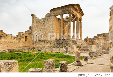 Ruins of ancient Roman capitol on territory of antic city of Dougga in area of modern Tunisia. 124370462