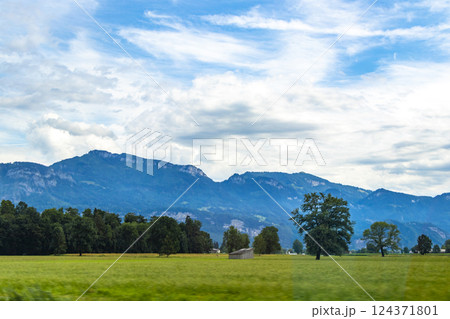 Mountain landscape mountains green fields forest clouds in Vorarlberg Austria. Mountain landscape mountains green fields forest clouds in Vorarlberg Austria. 124371801