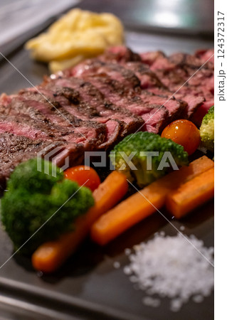 Medium rare rib eye angus steak served on plate Medium rare rib eye angus steak served on plate 124372317