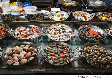 Snails and clams at Asian Street food night market in Vietnam. Vietnamese traditional seafood 124373053