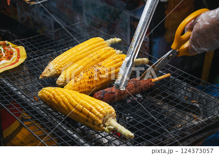 grilled corn and meat sausage grilled on fire at Asian street night market in Vietnam in Asia 124373057