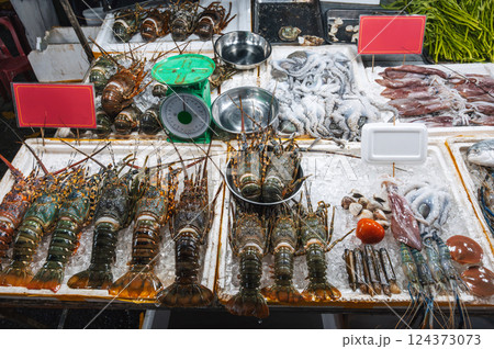 fresh lobsters and seafood on the counter at Asian night Food market in Vietnam in Asia 124373073
