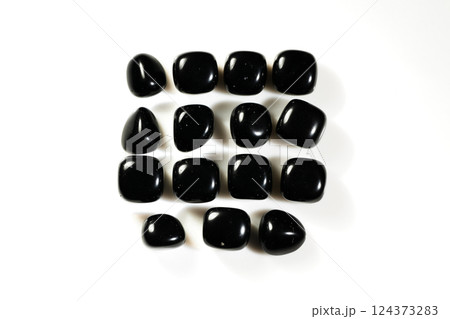Polished Black Natural Onyx Gemstones Arranged in Grid Pattern on White Background Polished Black Natural Onyx Gemstones Arranged in Grid Pattern on White Background 124373283