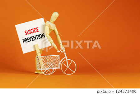 Suicide prevention symbol. Concept words Suicide prevention on beautiful white paper on clothespin. Beautiful orange table orange background. Psychological and suicide prevention concept. Copy space. Suicide prevention symbol. Concept words Suicide prevention on beautiful white paper on clothespin. Beautiful orange table orange background. Psychological and suicide prevention concept. Copy space. 124373400