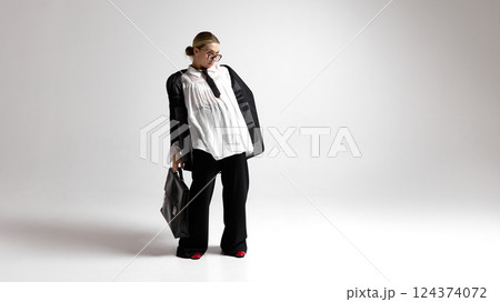 Confident, young woman, leader looking to side with surprised and curious expression against white studio background. 124374072