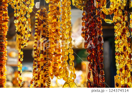 Amber Beads in a Street Shop. Orange Baltic Sea Souvenir, Natural Jewelry, Gold Brown Stone Necklace 124374514