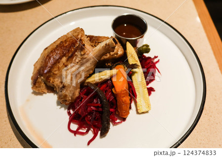 close up of grilled lamb meat mutton drumstick rack on a green plate with copy space 124374833