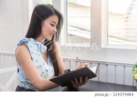 Young asian woman in smart casual wear working in home office. Social distance practice prevent coronavirus COVID-19. 124374964