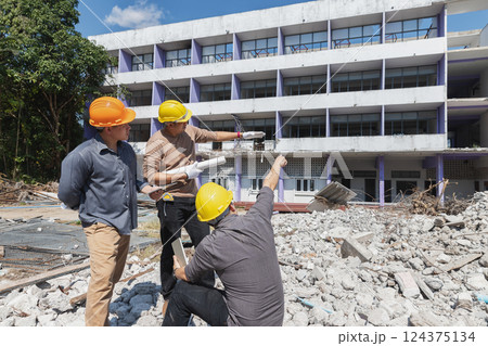 Demolition control supervisor and contractor discussing on demolish building. Demolition control supervisor and contractor discussing on demolish building. 124375134