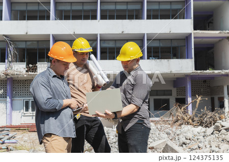 Demolition control supervisor and contractor discussing on demolish building. Demolition control supervisor and contractor discussing on demolish building. 124375135