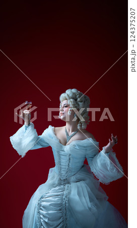 Royal indulgence. Portrait of woman holding wineglass in confident pose, showcasing elegance and ritual of aristocracy. Royal indulgence. Portrait of woman holding wineglass in confident pose, showcasing elegance and ritual of aristocracy. 124375207