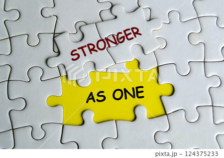 Stronger As One text on missing jigsaw puzzle. One Team and Unity concept 124375233
