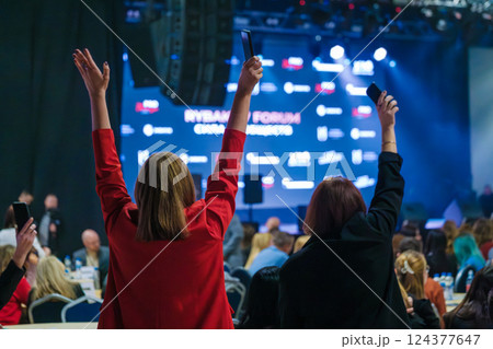 People enjoying a vibrant stage event with excitement and energy 124377647