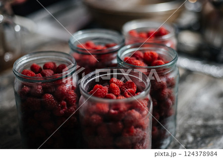 Raspberries in a glass jar. Preparation for making jam or compote. Home canning 124378984