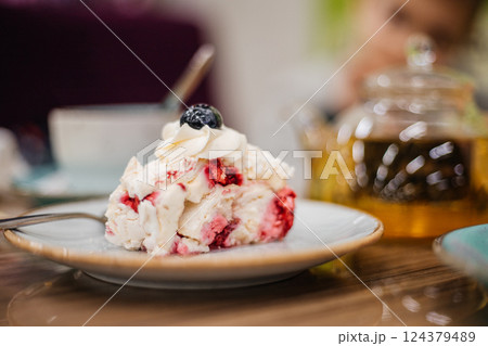 Beautiful delicious cake decorated with blueberries in a cafe - close-up 124379489