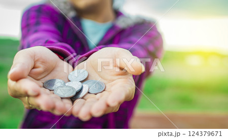 Close up of coins in hands, Nicaraguan coins in hands, savings concept 124379671