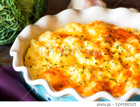 Cauliflower casserole with cheese and milk sauce in a baking dish 124380325