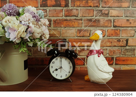 Alarm clock with home decoration on wooden background 124380904
