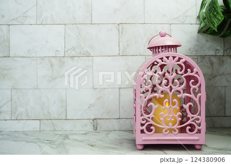 Pink candle light lantern home decoration on marble background 124380906