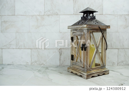 Wooden lantern on marble background 124380912