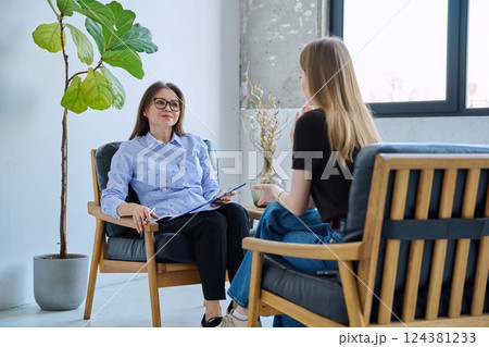 Female professional mental specialist, therapist working with patient young woman in office Female professional mental specialist, therapist working with patient young woman in office 124381233