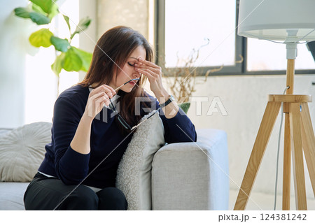 Mature sad woman experiencing stress, mental and physical pain, at home Mature sad woman experiencing stress, mental and physical pain, at home 124381242