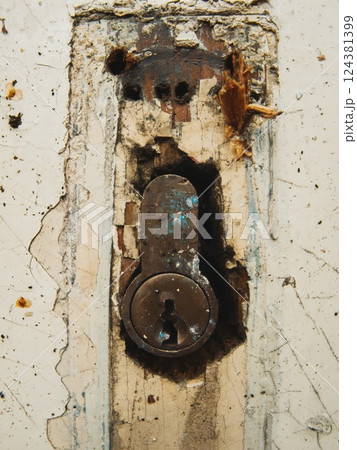 Close-Up of Old Rusty Keyhole on Damaged Door Close-Up of Old Rusty Keyhole on Damaged Door 124381399