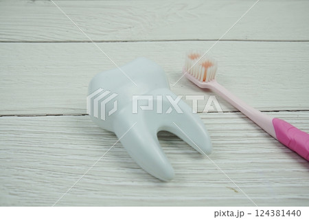 Toothbrush and Tooth dental hygiene concept top view on wooden background Toothbrush and Tooth dental hygiene concept top view on wooden background 124381440