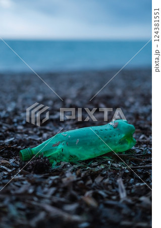 Plastic Bottle and Waste Polluting a Beach  124381551