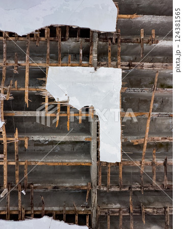 Cracked Concrete Ceiling with Exposed Wooden Reinforcement in Abandoned Building Cracked Concrete Ceiling with Exposed Wooden Reinforcement in Abandoned Building 124381565