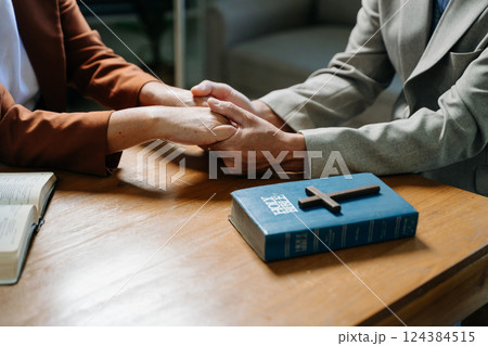 Two people reading and study bible in home and pray together.Studying the Word Of God 124384515