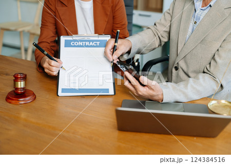 business people and lawyers discussing contract papers sitting at the table. Concepts 124384516