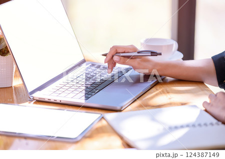 Hand of a businesswoman standing working with a laptop in the office. 124387149