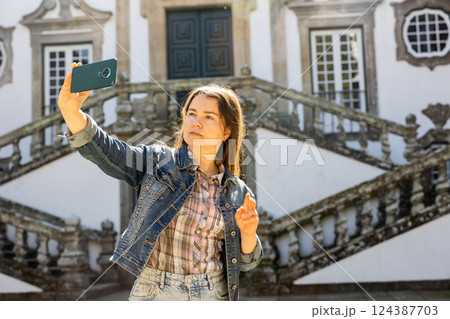 Woman with phone at Mateus Palace, Portugal Woman with phone at Mateus Palace, Portugal 124387703