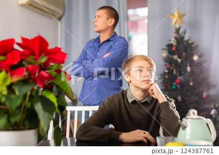 Father and son quarrel while celebrating christmas in home Father and son quarrel while celebrating christmas in home 124387761