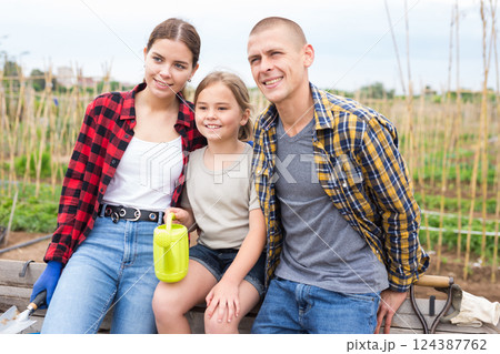 Portrait of friendly family in the backyard of cottage Portrait of friendly family in the backyard of cottage 124387762