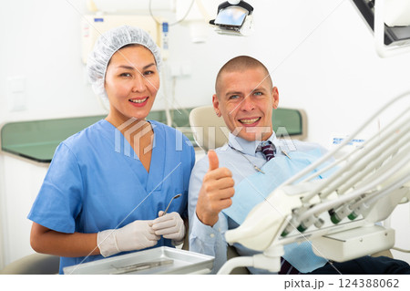 Man is sitting satisfied in chair after treatment in dental clinic 124388062