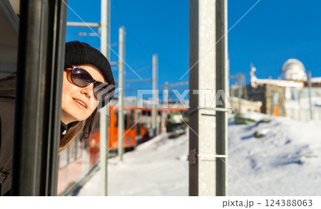 Woman traveler sticking head out of train window 124388063