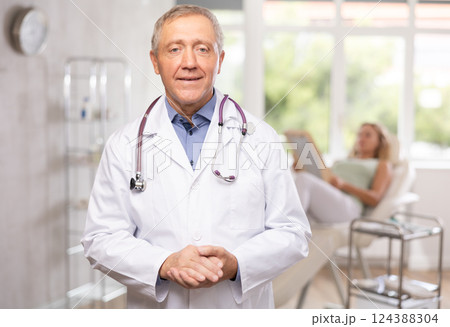 Mature male doctor represents services provided in medical clinic Mature male doctor represents services provided in medical clinic 124388304