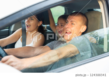 Man driver, his wife and doughter scared screaming in the car Man driver, his wife and doughter scared screaming in the car 124388341