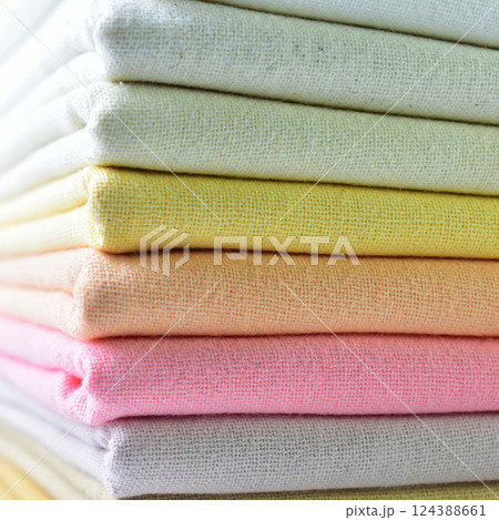 stack of colourful cotton clothes, close up pile of clothing 124388661