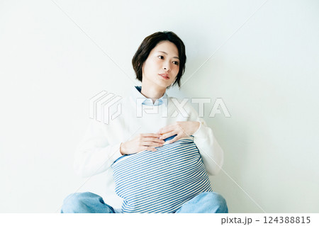 壁際で座る女性のポートレート 124388815