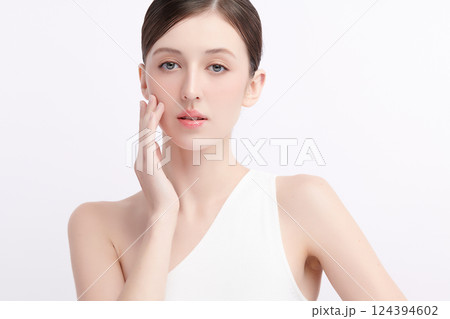 A beautiful young woman with clean, fresh skin against a white background. Skincare, facial treatment, cosmetology, beauty, and spa. An elegant portrait of an woman. A beautiful young woman with clean, fresh skin against a white background. Skincare, facial treatment, cosmetology, beauty, and spa. An elegant portrait of an woman. 124394602