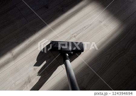 Vacuum cleaning dust on a floor Vacuum cleaning dust on a floor 124394694