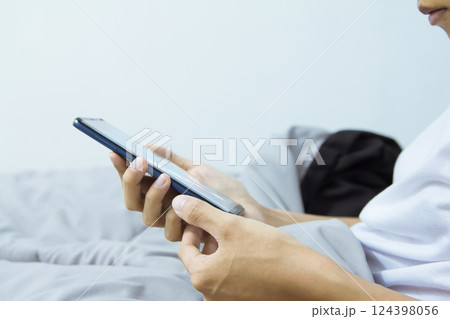 woman pointing, look directions change Average line Share price movement Stock trade up and down economy on smartphone work in the bedroom woman pointing, look directions change Average line Share price movement Stock trade up and down economy on smartphone work in the bedroom 124398056