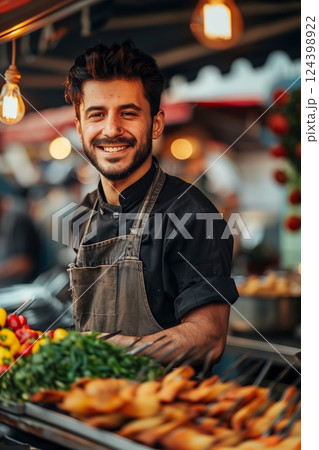 A cheerful vendor smiles at the food market, showcasing fresh ingredients and delicious snacks. 124398922